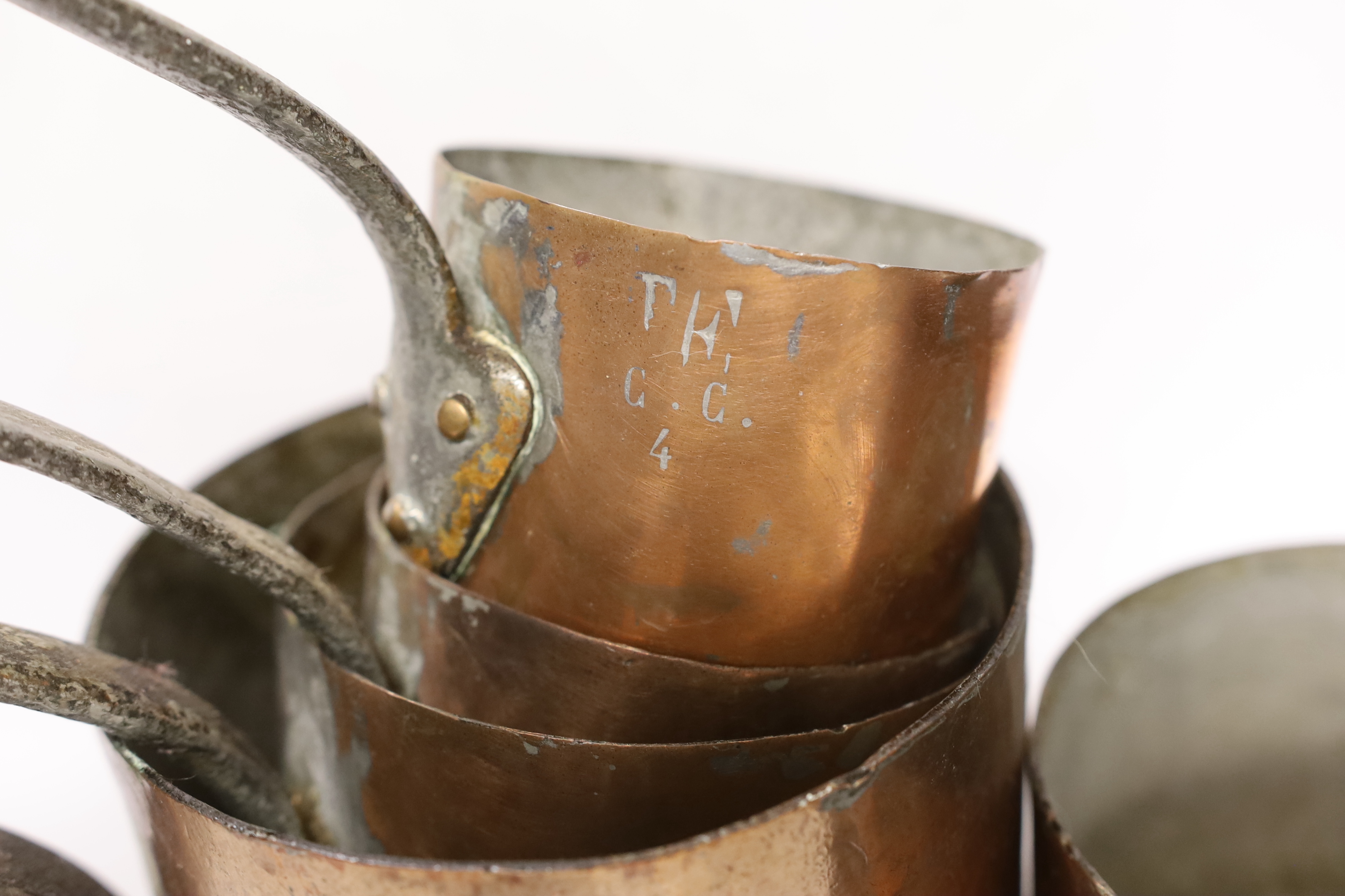 A set of five French graduated copper saucepans, largest 33cm wide